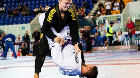 A competitor works to pass the guard in a Brazilian Jiu Jitsu competition