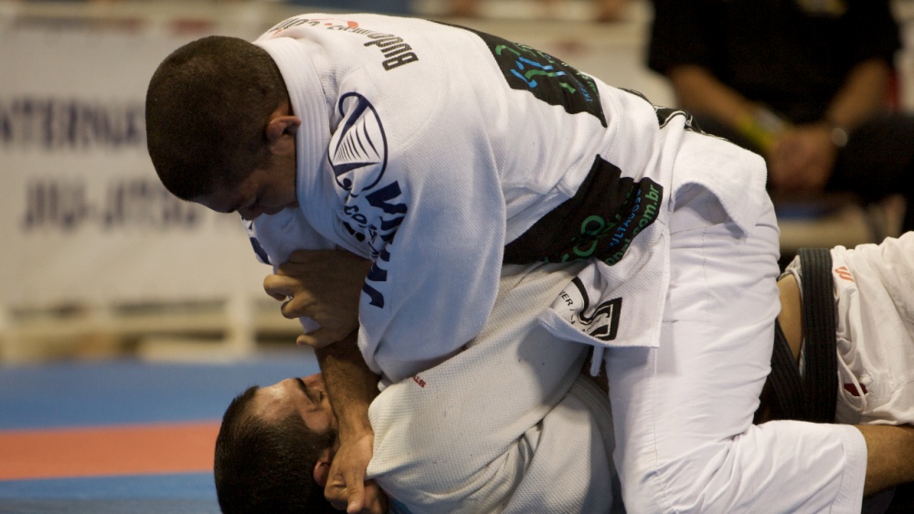 A Brazilian jiu jitsu competitor using strength with proper technique in competition