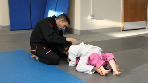 4-year-old child practicing Brazilian Jiu-Jitsu during a kids class in Ocean Township, NJ