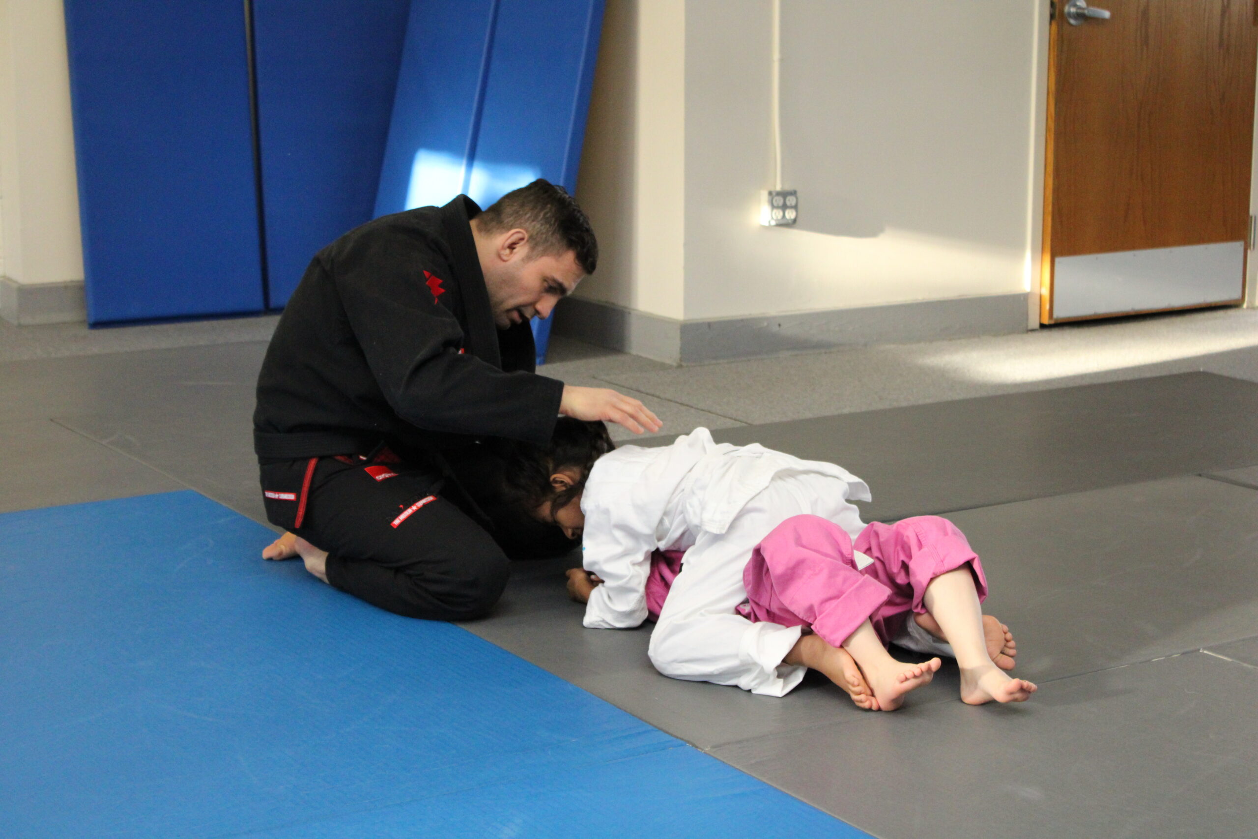 4-year-old child practicing Brazilian Jiu-Jitsu during a kids class in Ocean Township, NJ