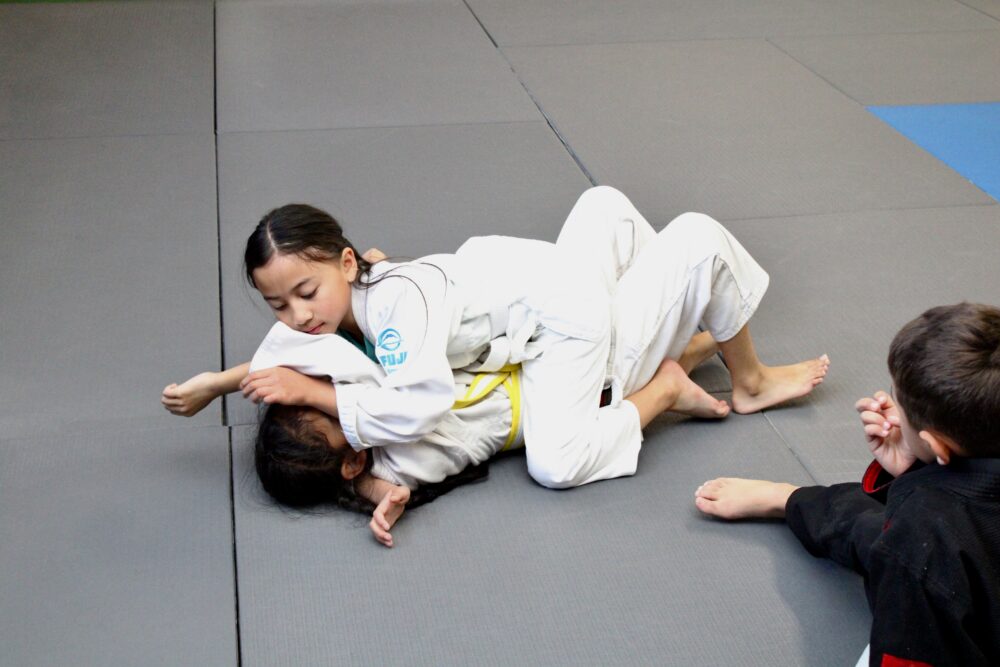 Kids Brazilian Jiu-Jitsu student practicing the mount position in Ocean Township NJ