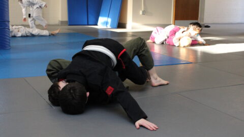 Kids practicing the mount position during Brazilian Jiu-Jitsu class in Ocean Township NJ