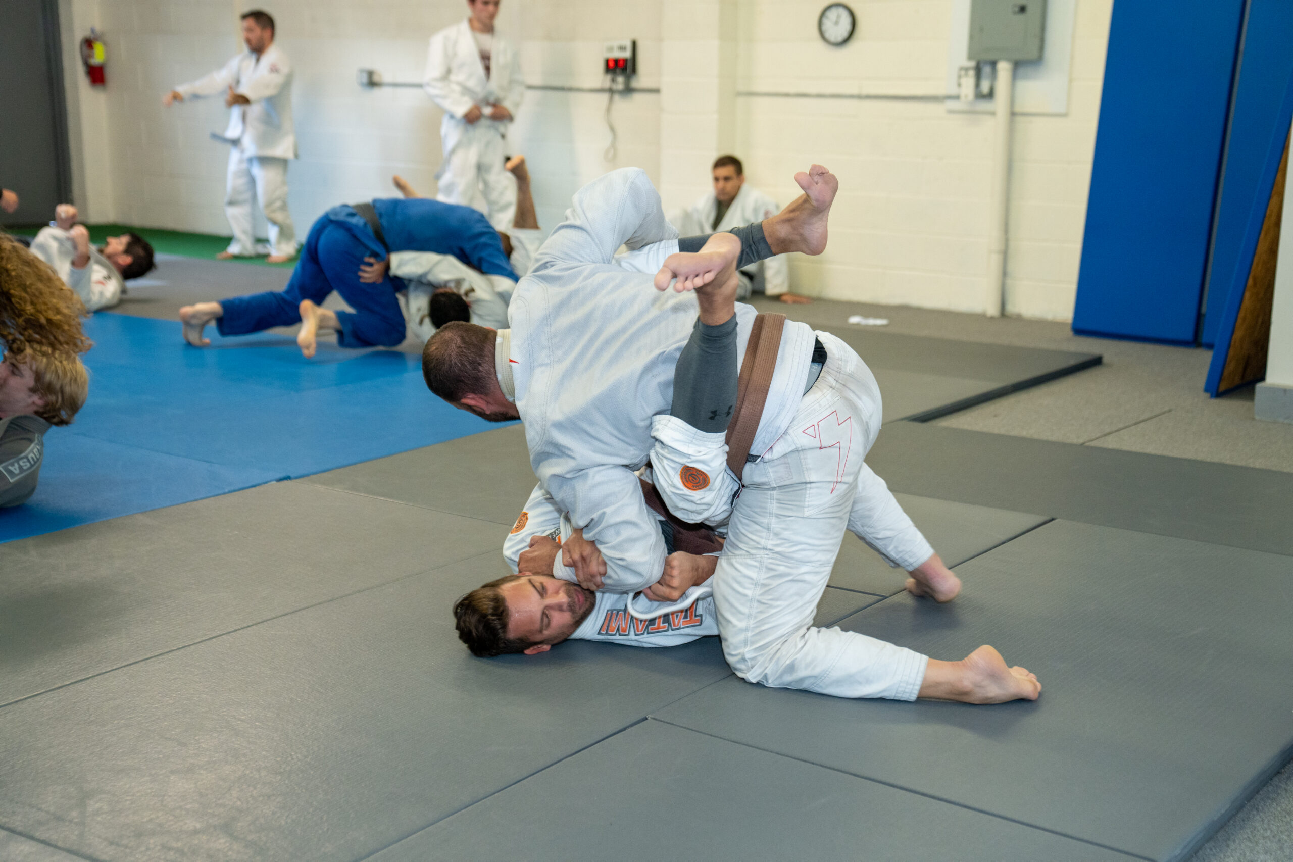 Students sparring in Brazilian Jiu-Jitsu class three times a week