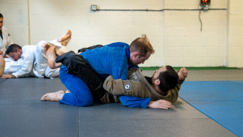 Two students drilling a submission from closed guard during a Brazilian Jiu-Jitsu class