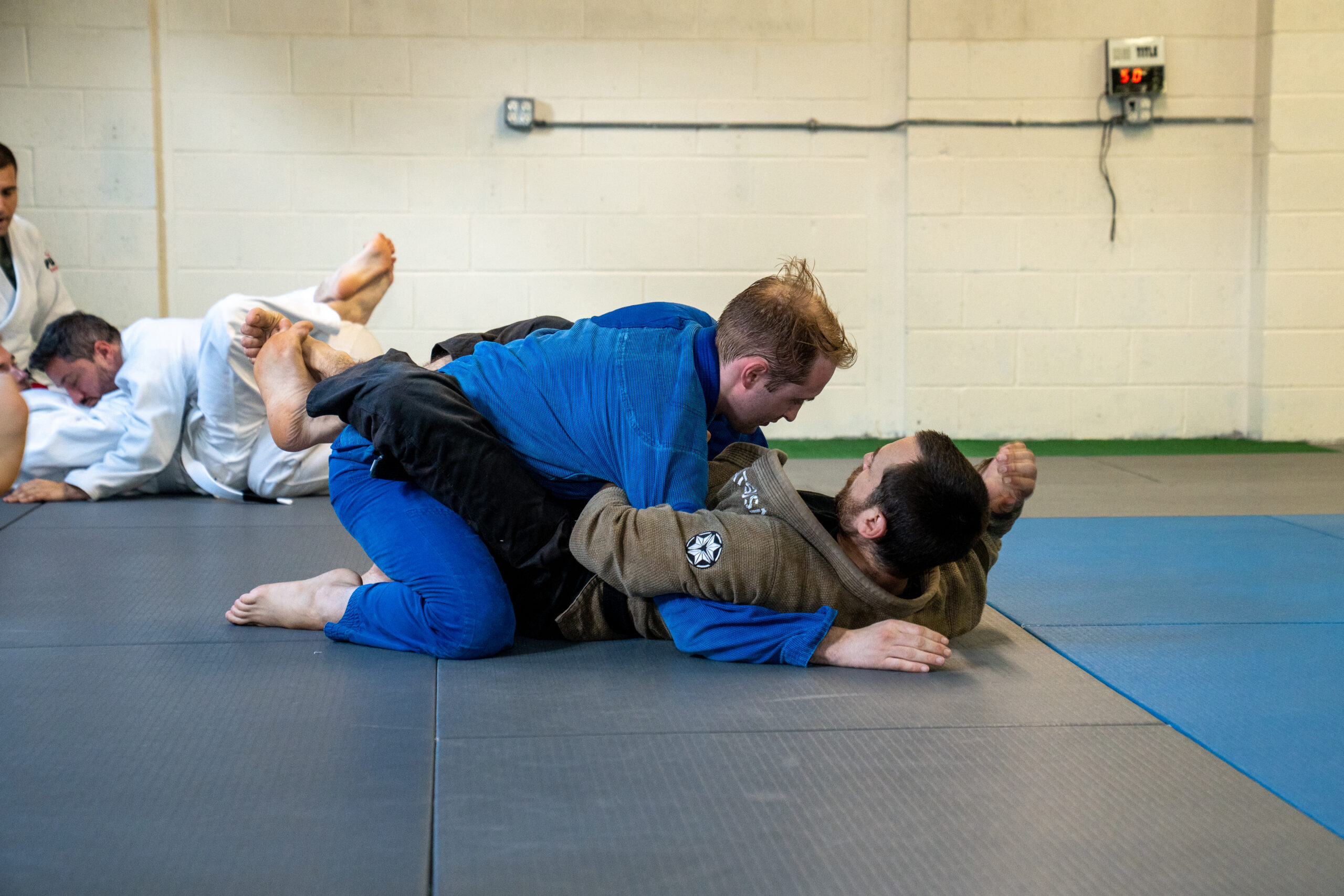 Two students drilling a submission from closed guard during a Brazilian Jiu-Jitsu class